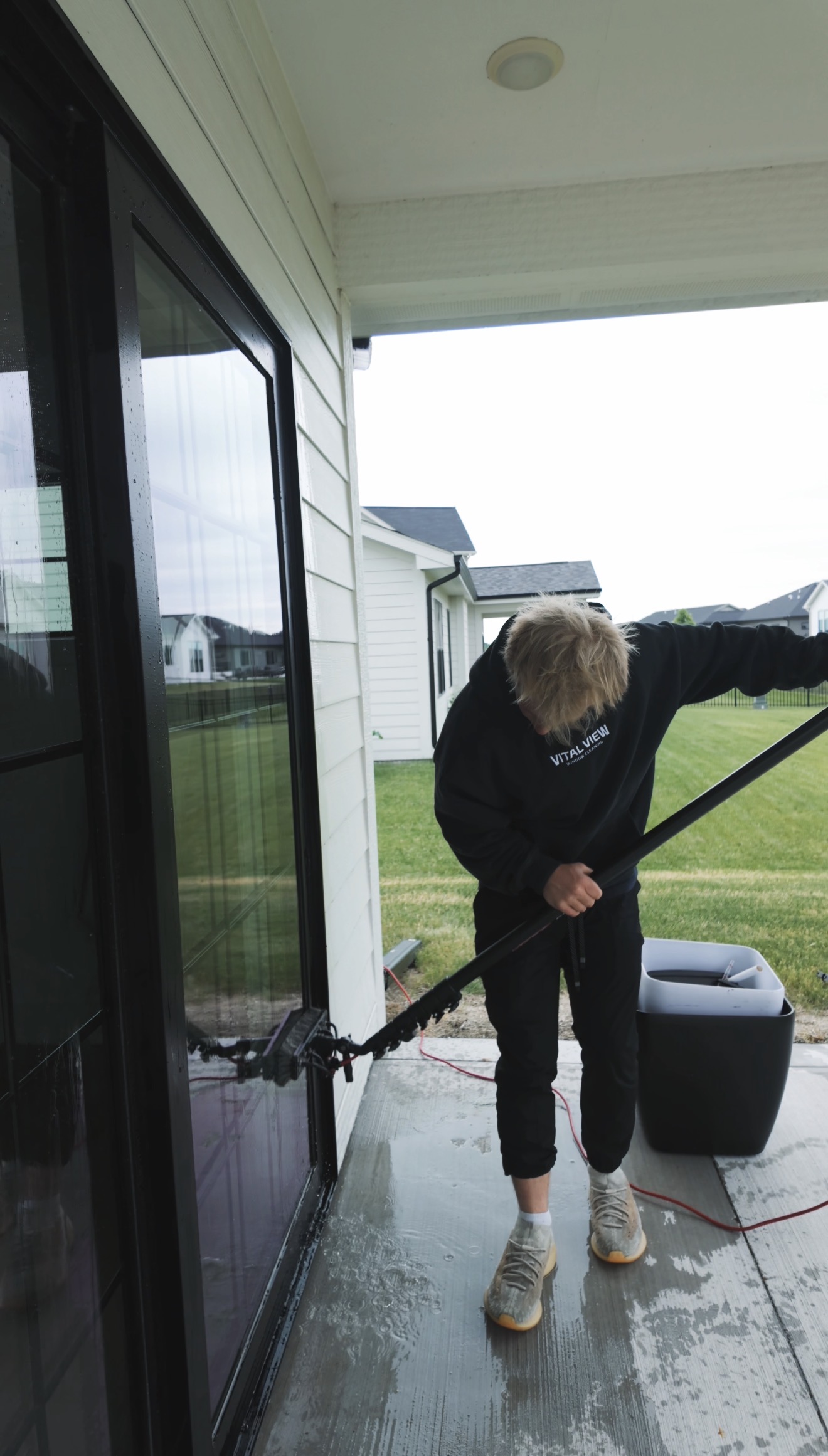 Scrub — exterior window cleaning step